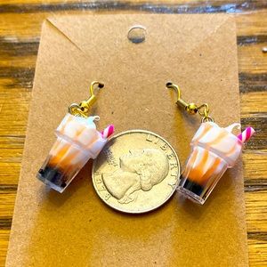 Cute orange milkshake earrings with gold looking wires and a random gift bag